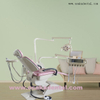 Sillón dental de color rosa con sistema de pantalla táctil